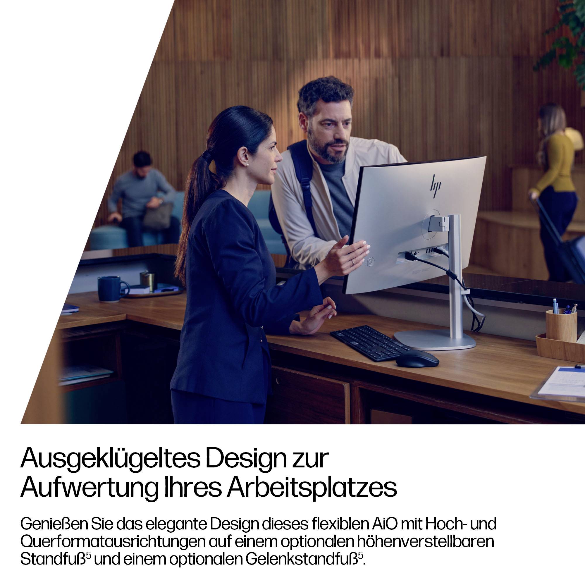 Eine Frau und ein Mann diskutieren über Arbeit in einem Büro in der Nähe eines Desktop-Computers. Der Text auf Deutsch bewirbt ein flexibles, elegantes Arbeitsplatzdesign.