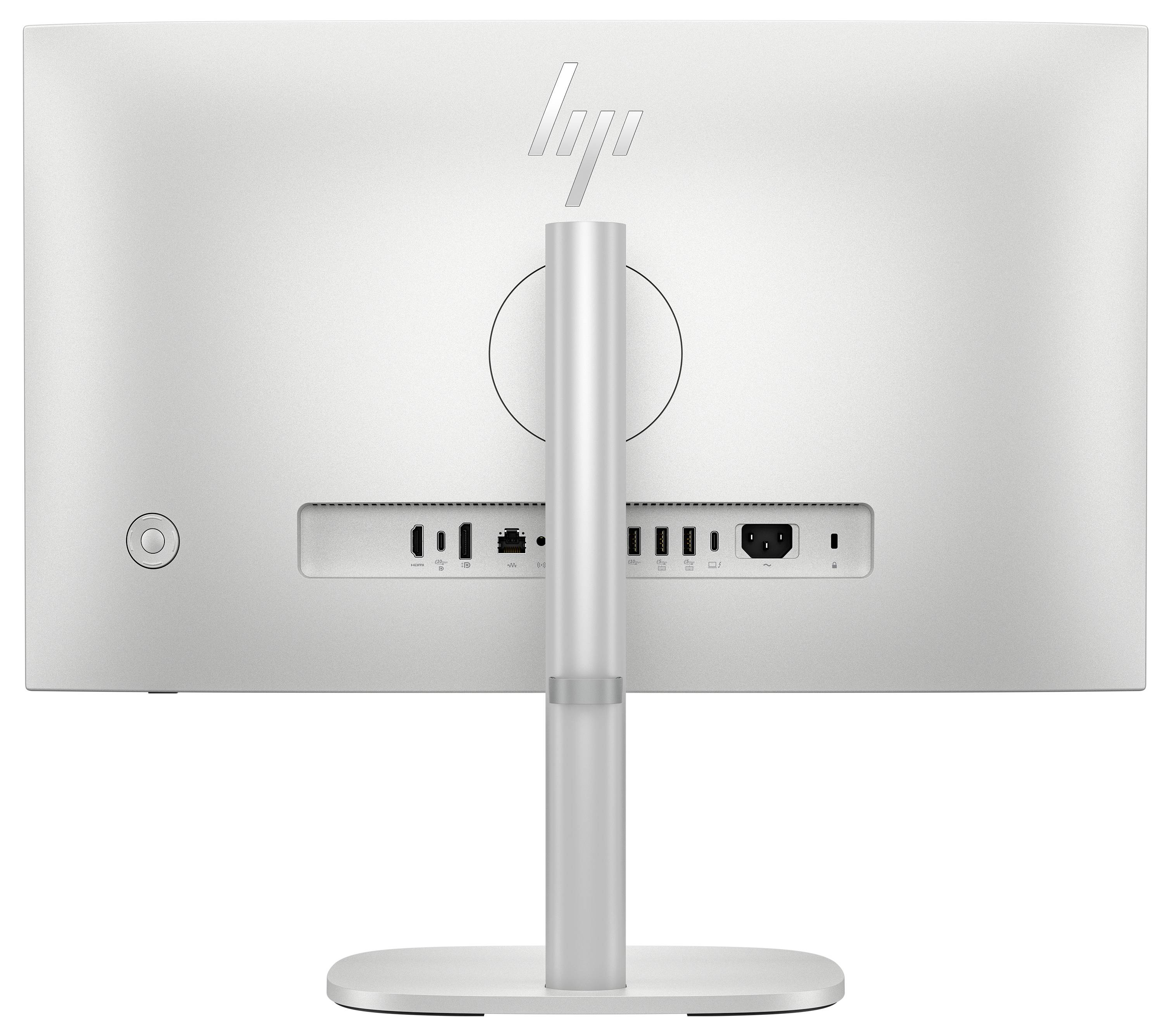 Das Bild zeigt die Rückseite eines Computermonitors mit einem silbernen Ständer, der mehrere Anschlüsse wie HDMI, USB und Ethernet aufweist.