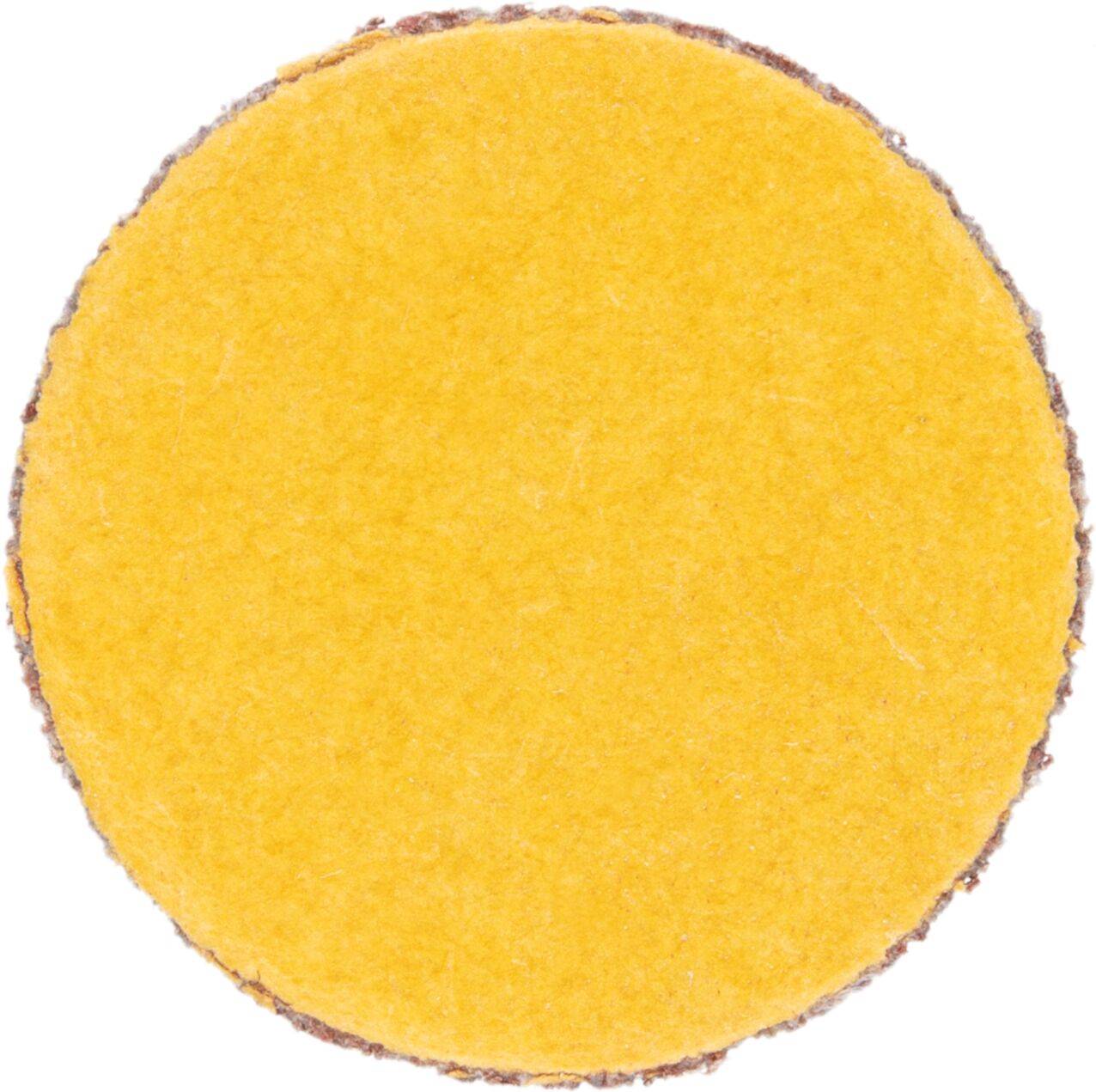 Eine gelbe runde Schleifscheibe mit rauen Kanten, die zum Glätten von Oberflächen verwendet wird.