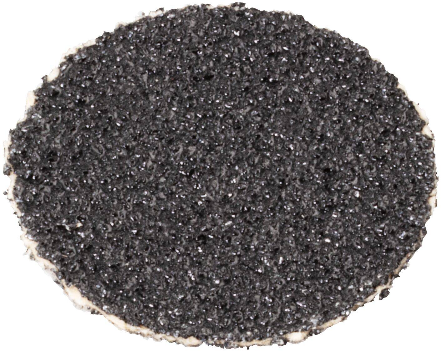 Eine strukturierte, kreisförmige, raue schwarze Oberfläche, möglicherweise eine Probe von Asphalt oder ähnlichem Material, von oben betrachtet, vor einem weißen Hintergrund.