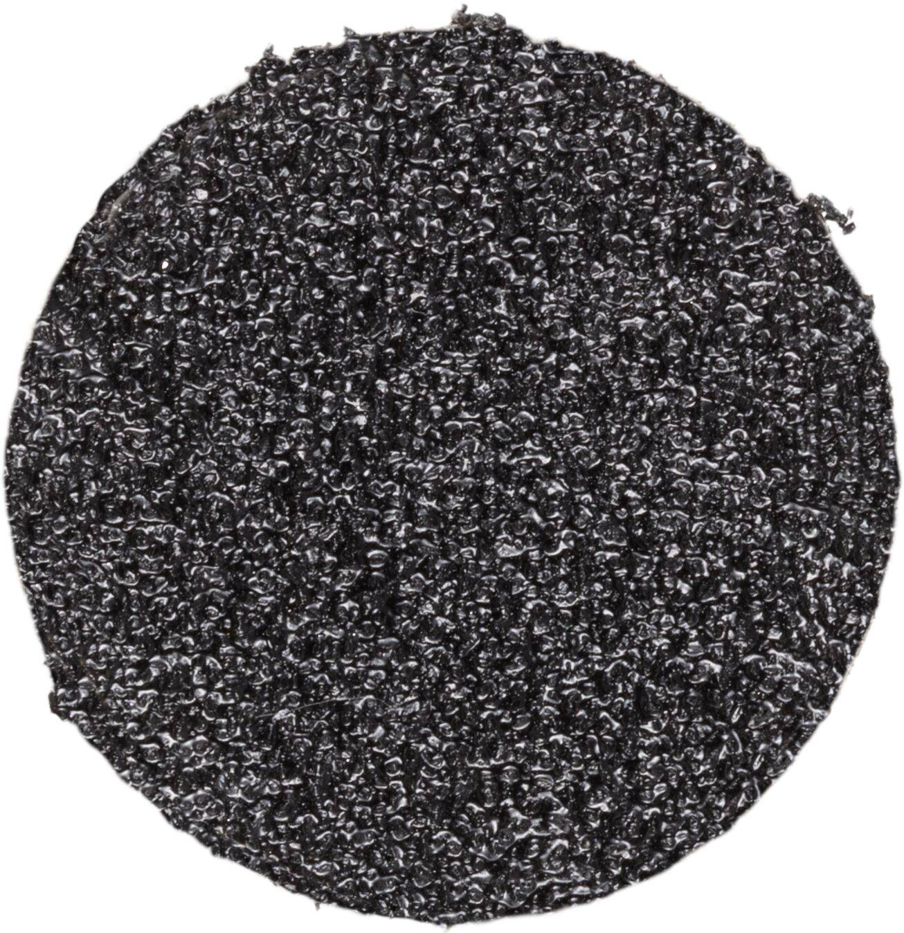 Ein kreisförmiges Stück schwarzes Material mit einer rauen, texturierten Oberfläche, die einem Scheuerschwamm ähnelt.