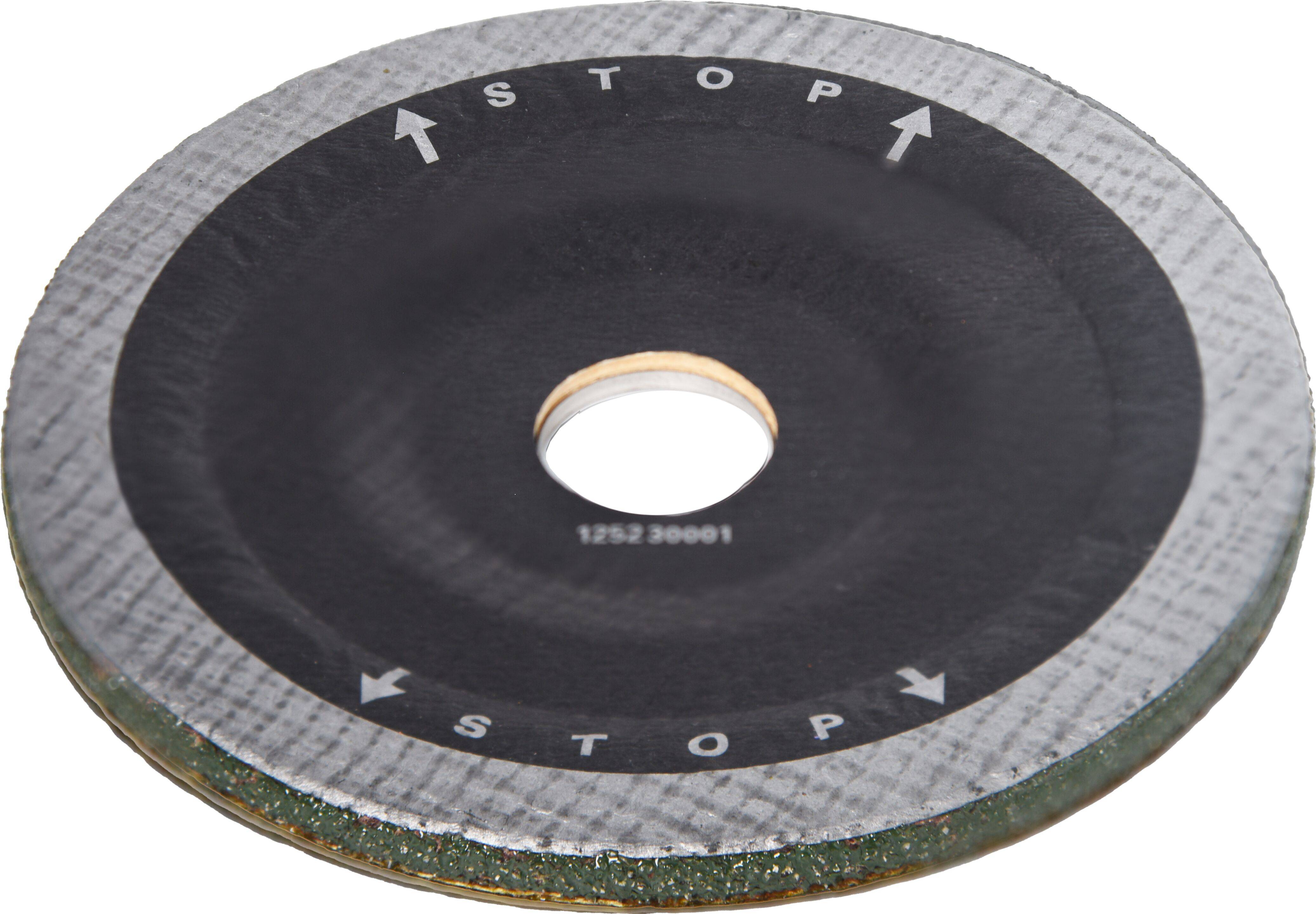 Eine kreisförmige Schleifscheibe mit Pfeilen, die eine Stopprichtung anzeigen, wird dargestellt. Der äußere Rand ist strukturiert, und in der Mitte befindet sich ein Loch.
