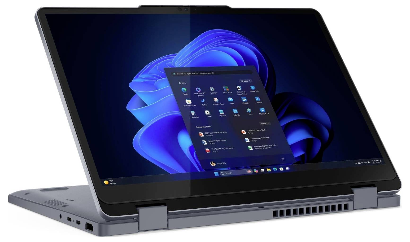 Ein Convertible-Laptop im Zeltmodus, der den Bildschirm des Windows-Betriebssystems mit Anwendungssymbolen zeigt, vor einem dunkelblauen abstrakten Hintergrund.