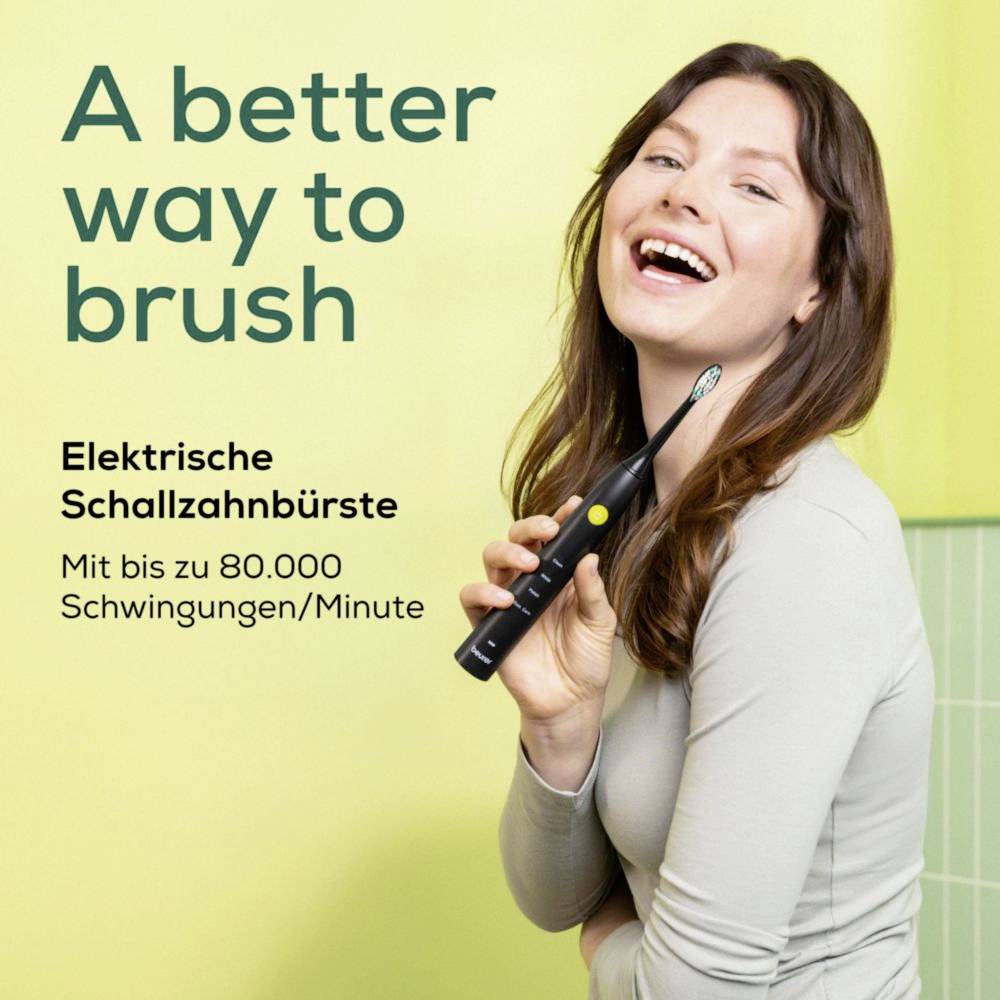 A woman smiles holding an electric toothbrush. Text reads 'Eine bessere Art zu putzen. Elektrische Schallzahnbürste: Mit bis zu 80.000 Schwingungen/Minute.'