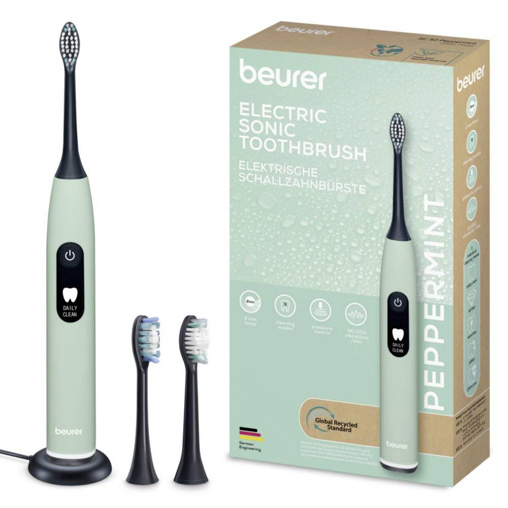 'Beurer Elektrische Schallzahnbürste Daily Clean' in einer Pastellgrün-Nuance mit zwei Ersatzköpfen. Kartonaufschrift: 'Electric Sonic Toothbrush' auf Englisch und Deutsch.