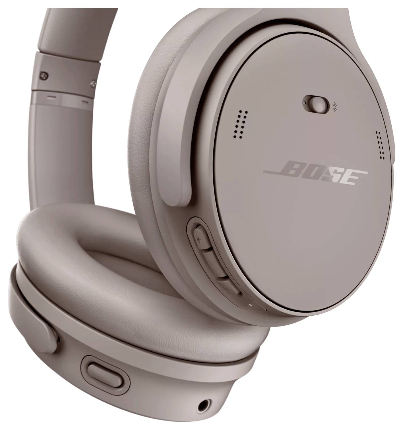 Nahaufnahme von Over-Ear-Kopfhörern in einer hellen Farbe, die das Markenlogo, die Ohrpolster und die Bedienungsknöpfe an der Seite zeigt.