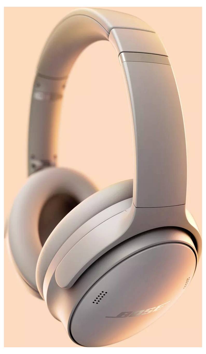 Silberne drahtlose Kopfhörer mit gepolsterten Ohrmuscheln und Kopfbügel, Schrägansicht vor einem Pfirsichhintergrund.