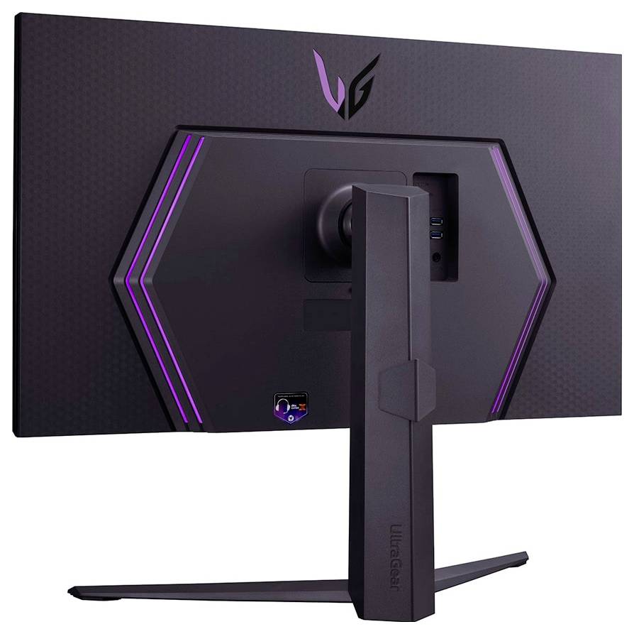 Rückansicht eines Gaming-Monitors mit einem sechseckigen Design und lila LED-Beleuchtung. Der Monitorständer zeigt ein Logo und die Anschlüsse sind sichtbar.