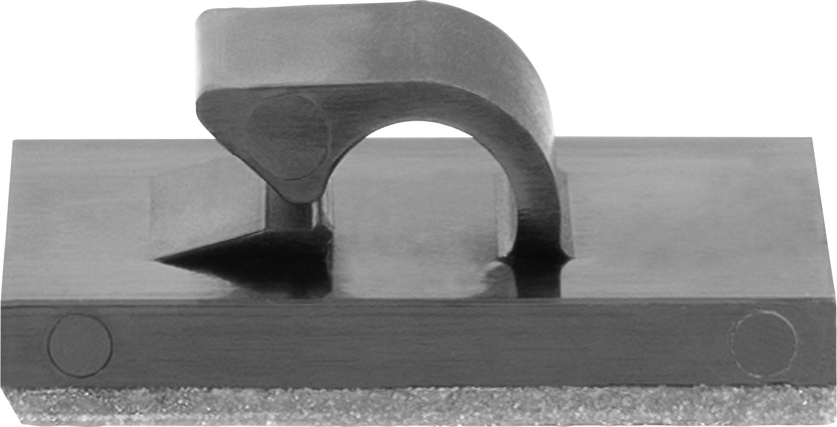 Ein rechteckiger metallischer Gegenstand mit einem zentralen gebogenen Griff oben, der einem Werkzeug oder Teil eines Mechanismus ähnelt, auf einer flachen Oberfläche platziert.