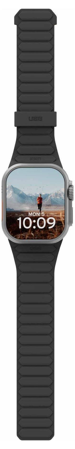 Smartwatch mit einem schwarzen Armband zeigt die Zeit '10:09' und ein Hintergrundbild einer Person, die in einer bergigen Landschaft steht.