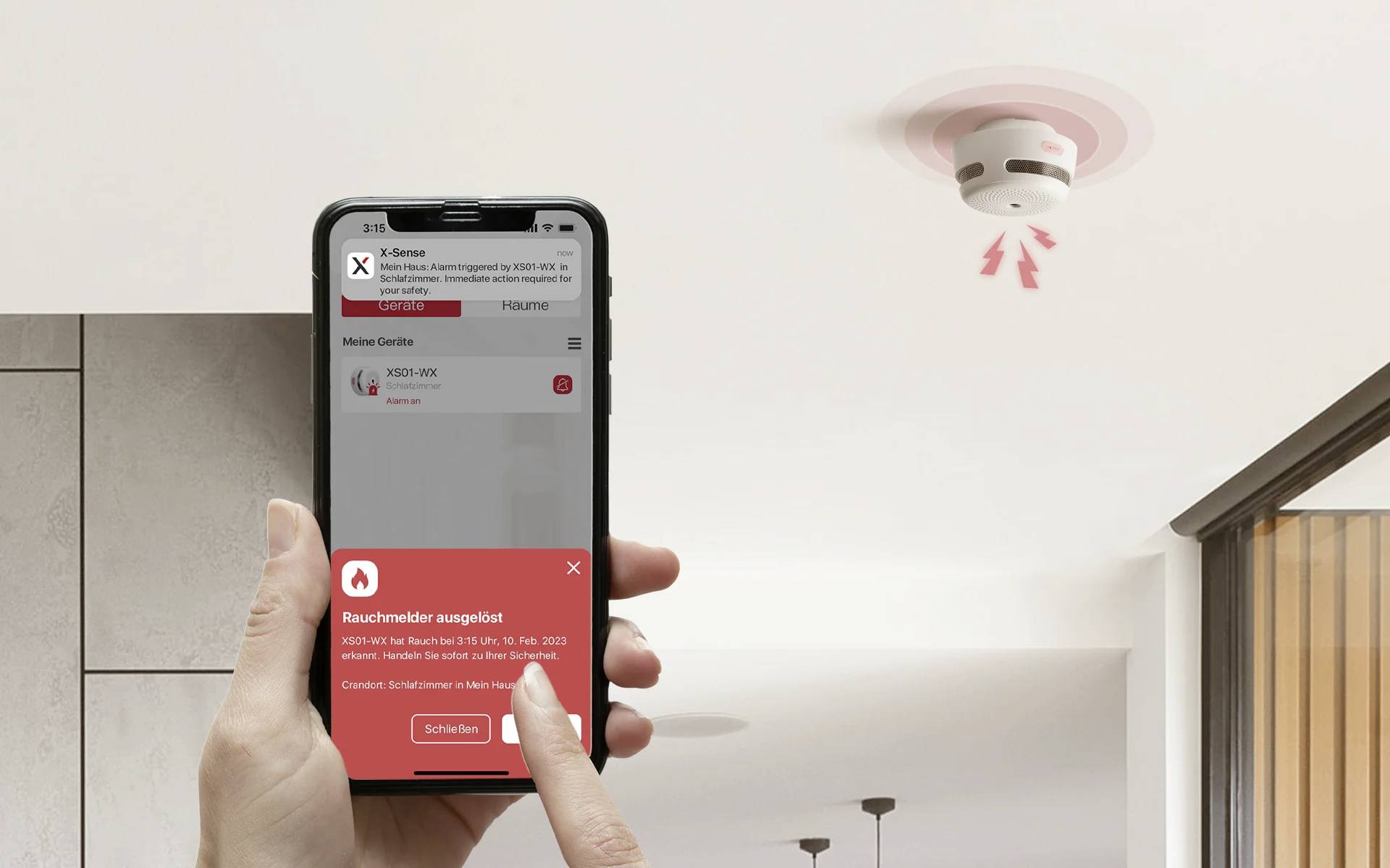 Person hält ein Smartphone, das eine Rauchmelder-Warnung anzeigt. An der Decke ist ein aktivierter Rauchmelder zu sehen.