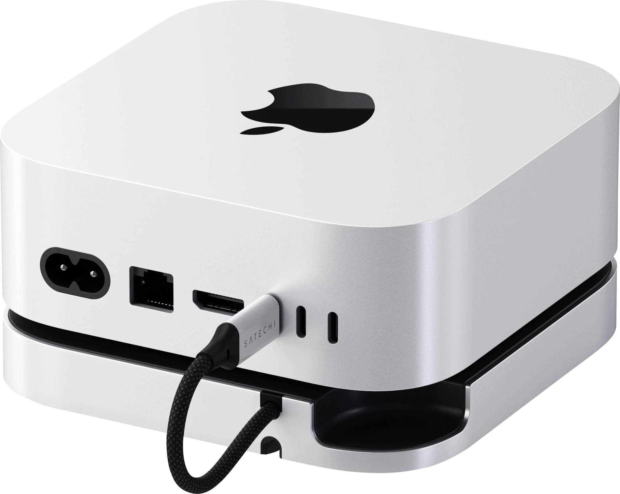 Ein kleines, silbernes Gerät mit einem Apple-Logo, das an der Rückseite Anschlüsse für Strom-, USB- und HDMI-Kabel aufweist. Ein Kabel ist eingesteckt.