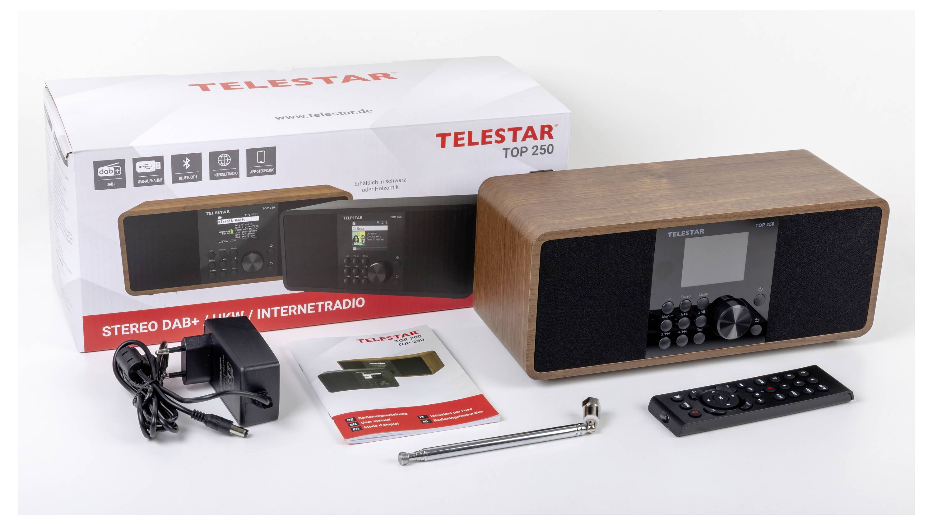 Karton und Inhalt des Telestar Top 250 Stereo. Enthält DAB+ Radio mit Holzoptik, Netzteil, Fernbedienung, Bedienungsanleitung und Antenne.