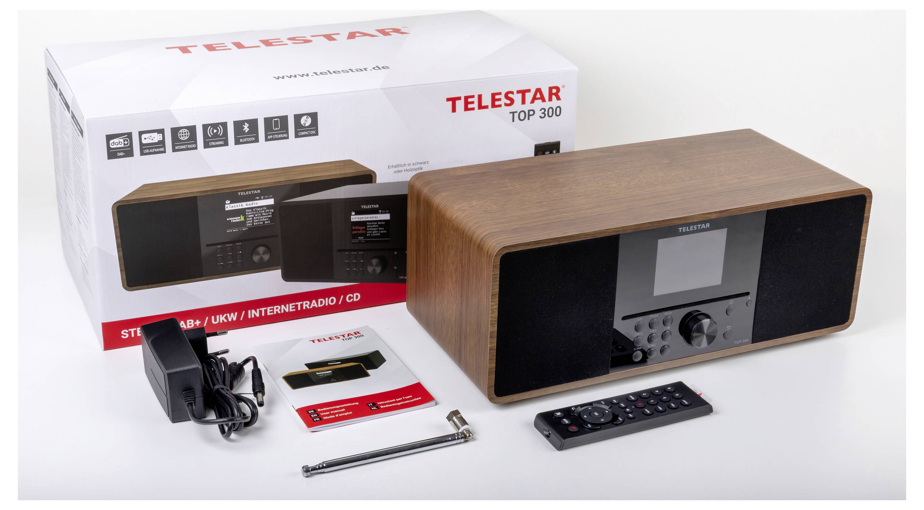 Ein Telestar Top 300 Radiogerät mit Karton, Netzteil, Fernbedienung, Antenne und Handbüchern. Das Radio verfügt über Internetradio- und CD-Funktionen.
