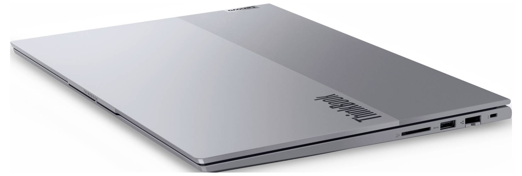Ein geschlossener silberner Laptop der Marke 'ThinkBook' mit USB-Anschlüssen an der Seite und einem schlanken, minimalistischen Design.