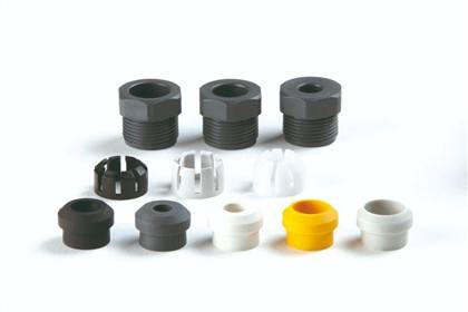Anordnung verschiedener Gewindearmaturen und Schutzkappen in Schwarz, Weiß und Gelb, die unterschiedliche Größen und Designs präsentieren.