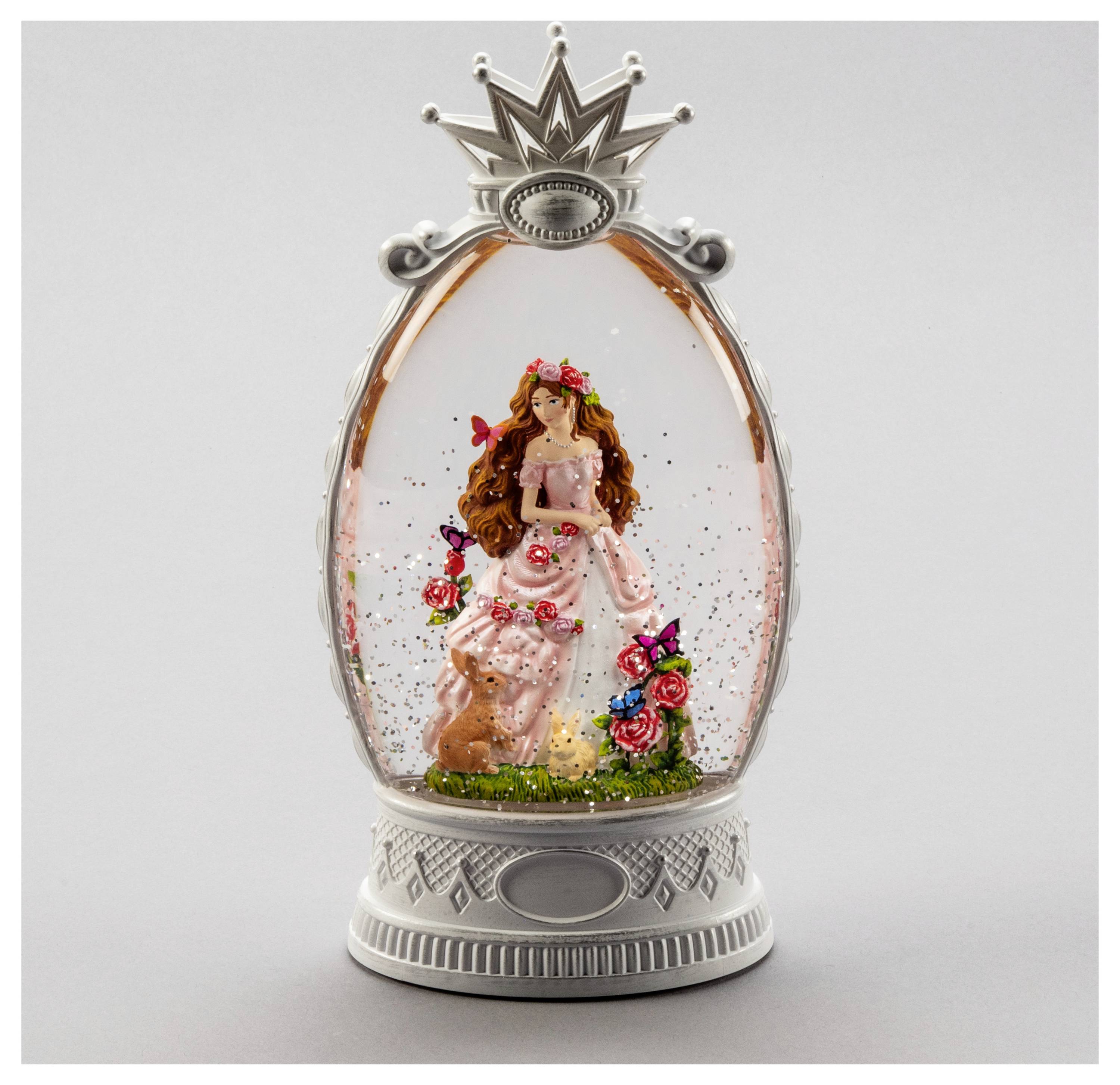 Eine Figur einer Prinzessin in einem rosa Kleid mit Blumen, Krone und Schloss, eingeschlossen in einer dekorativen Schneekugel mit Glitzer.