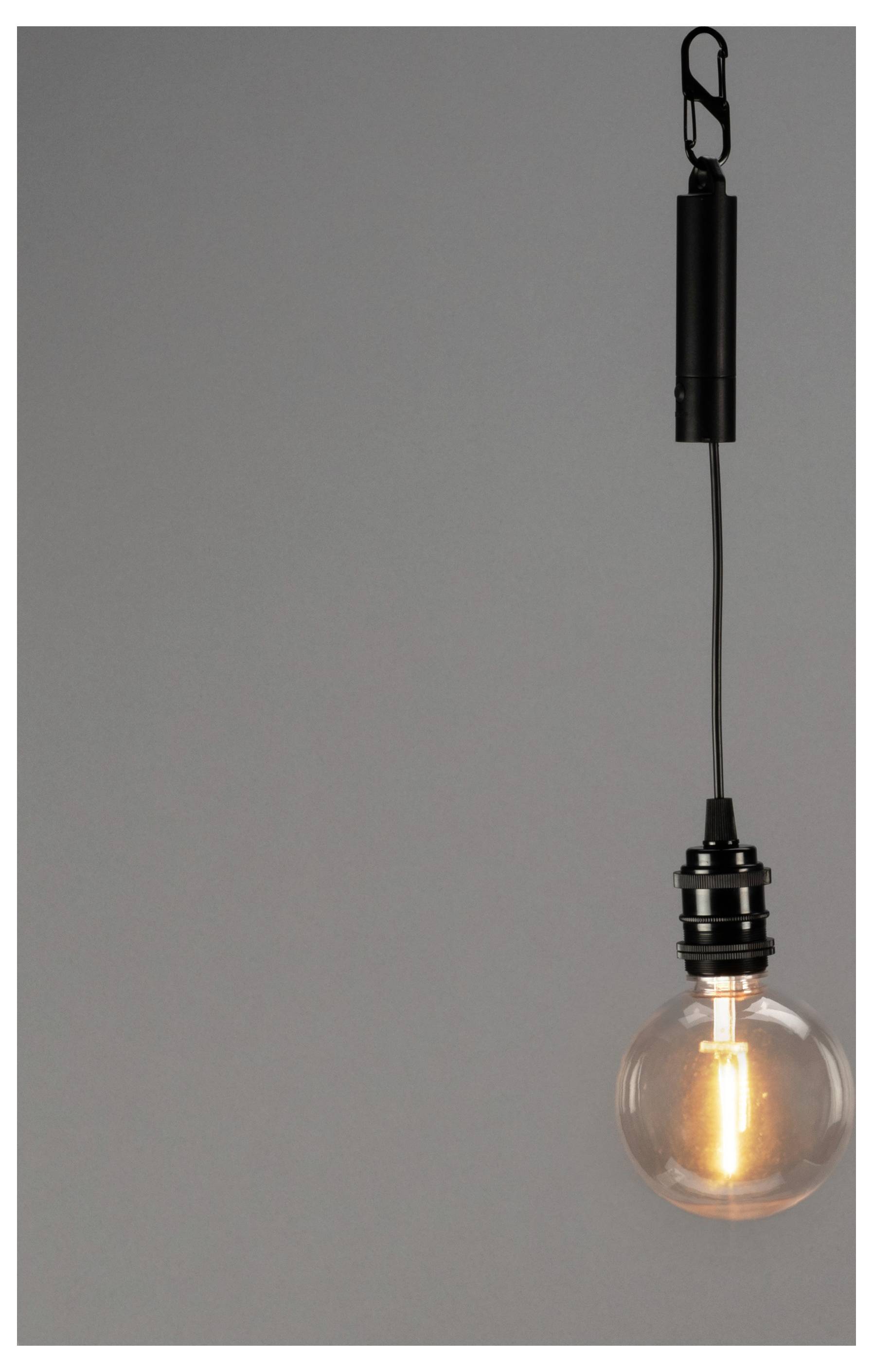 Eine einzelne hängende Glühbirne mit sichtbarem Glühdraht ist vor einem einfarbigen grauen Hintergrund aufgehängt und vermittelt einen minimalistischen Eindruck.