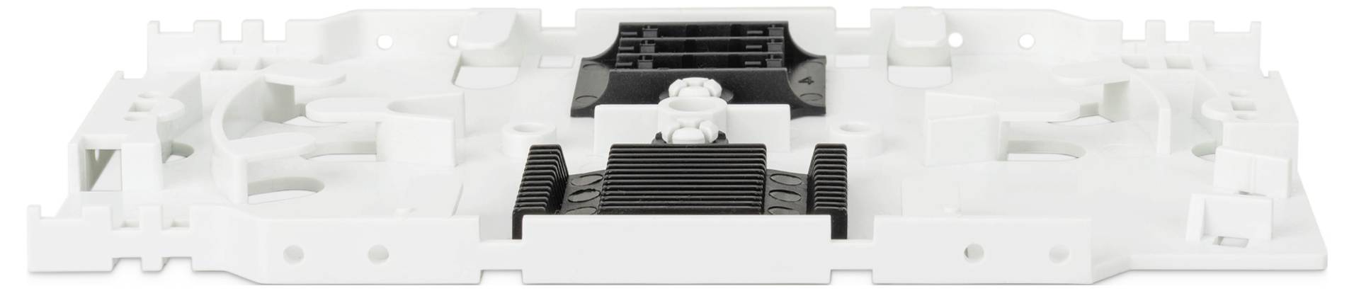 Eine weiße und schwarze Plastikkomponente, möglicherweise ein elektronisches oder mechanisches Bauteil, mit verschiedenen Schlitzen, Rippen und Befestigungspunkten.