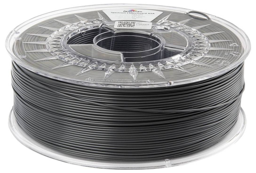 Eine Spule mit 3D-Druckerfilament, beschriftet als ‚Shaxon Nylon 1.75mm', Farbe schwarz. Die Spule verfügt über transparente Seiten, um die verbleibende Filamentmenge zu überblicken.