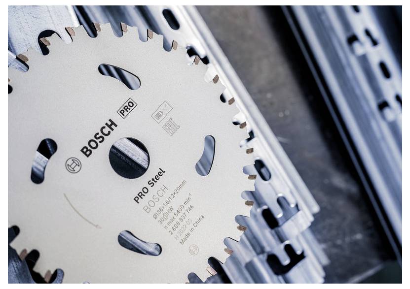 Kreissägeblatt mit 'Bosch Pro Steel'-Branding wird auf Metallschienen platziert, was auf eine Verwendung zum Schneiden von Metallmaterialien hindeutet.