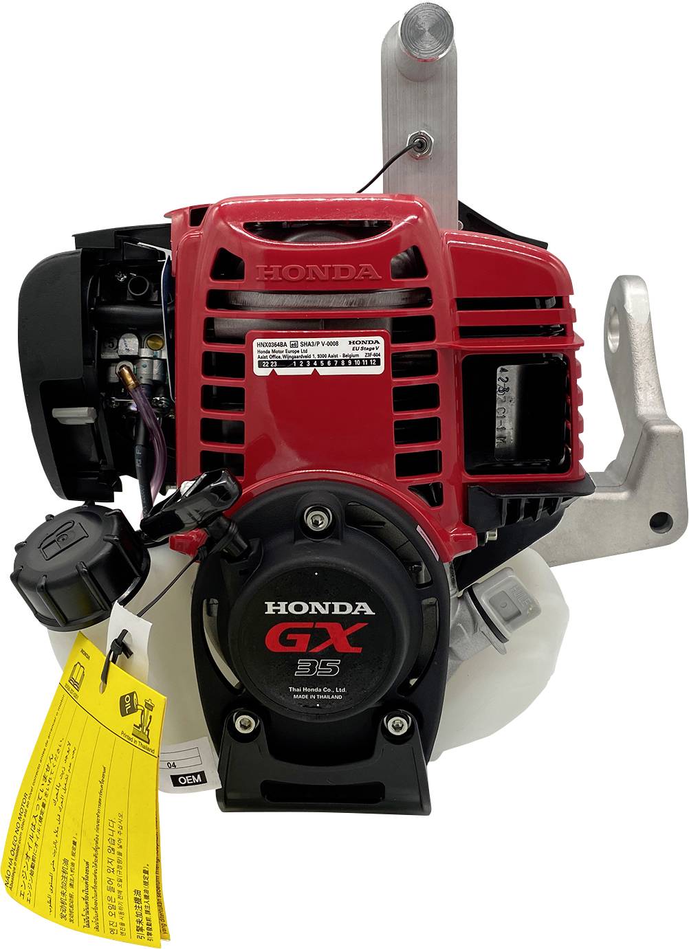 Ein kompakter roter und schwarzer Honda GX35-Motor mit einem gelben Sicherheitsetikett. Sichtbare Teile umfassen den Kraftstofftank und den Seilzugstarter.