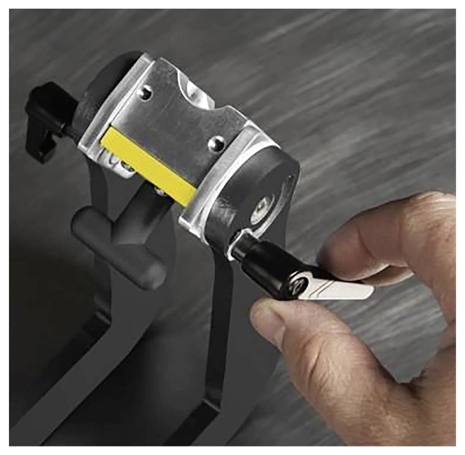 Eine Person verwendet einen Schlüssel, um ein robustes Radschloss auf dem Reifen eines Fahrzeugs zu befestigen und zeigt damit die sichere Diebstahlschutzfunktion des Mechanismus.