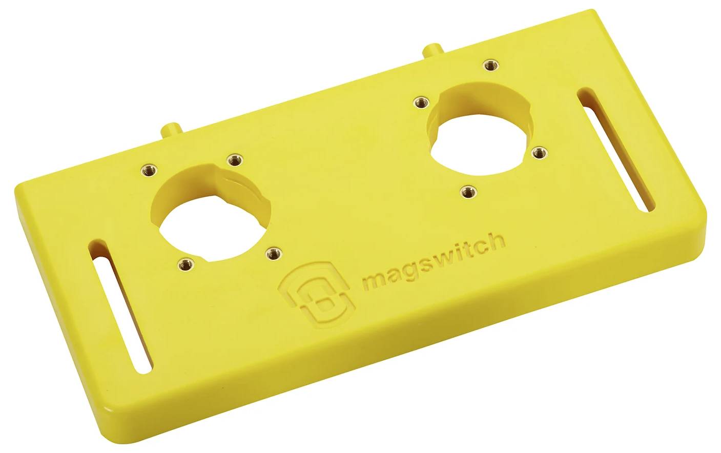 Gelbe Kunststoffbasis mit zwei runden Aussparungen und Schlitzen, geprägt mit 'magswitch'. Wird als Montagehalterung oder Vorlage für Werkzeuge verwendet.