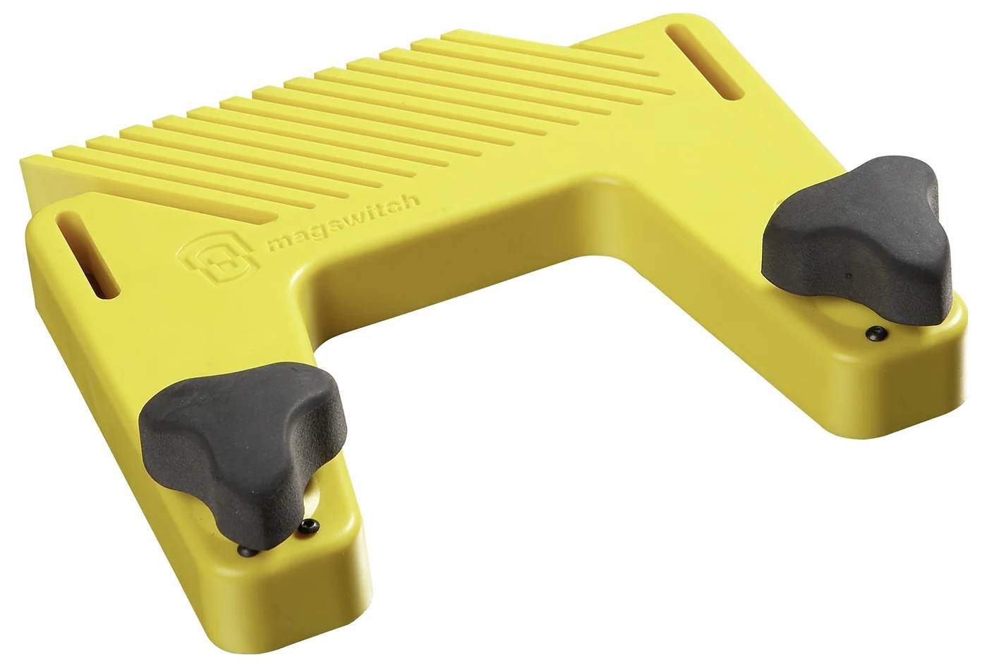 Ein gelbes Werkzeug mit zwei schwarzen Knöpfen, das zum Halten oder Stabilisieren von Gegenständen verwendet wird. Die Oberfläche weist Rillen für besseren Halt auf.