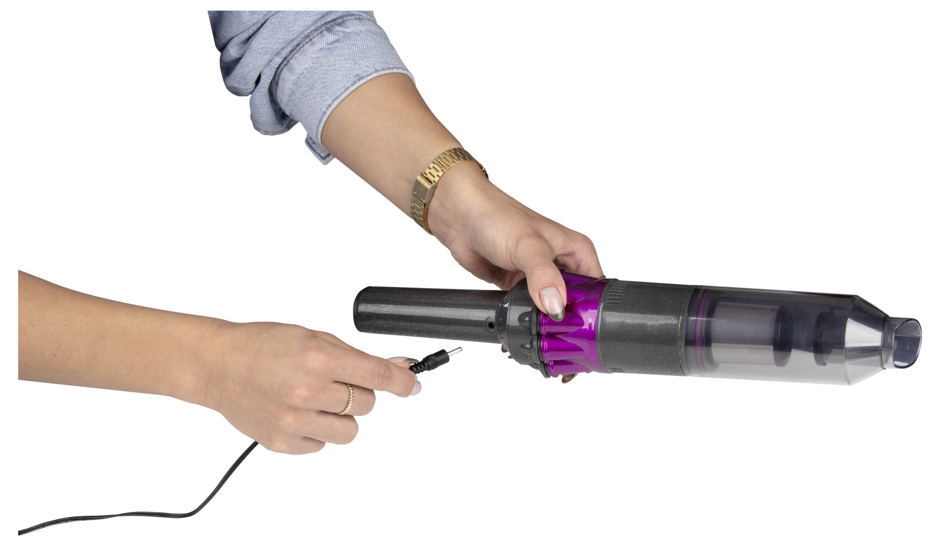 Eine Person steckt ein Ladekabel in einen Handstaubsauger und demonstriert damit den Ladevorgang des Geräts.