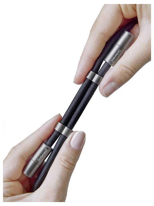 Hände, die ein schwarzes Mesh-Stressabbau-Spielzeug mit Metallenden halten, mit der Beschriftung ‚inhand'.