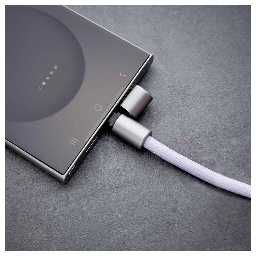 Smartphone, das an ein weißes Kabel auf einer grauen Oberfläche angeschlossen ist und lädt. Die Anzeige zeigt den Ladestatus.