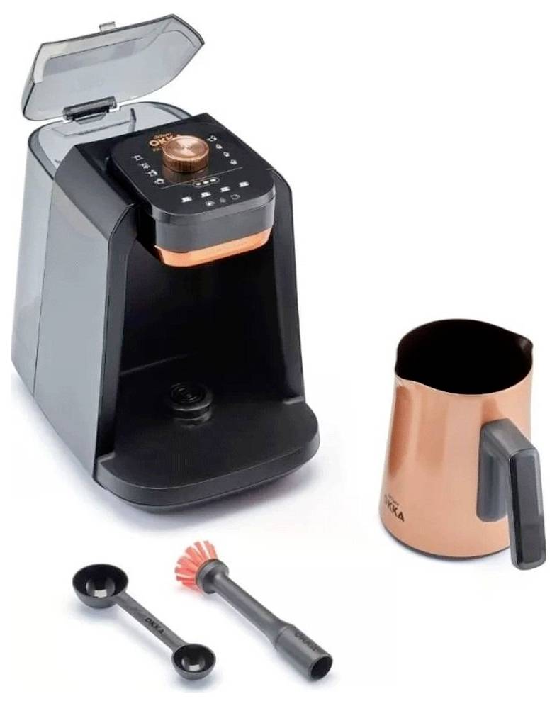 Eine kompakte Kaffeemaschine mit digitaler Anzeige und offenem Deckel, begleitet von einem kupferfarbenen Milchaufschäumkrug und Reinigungswerkzeugen.