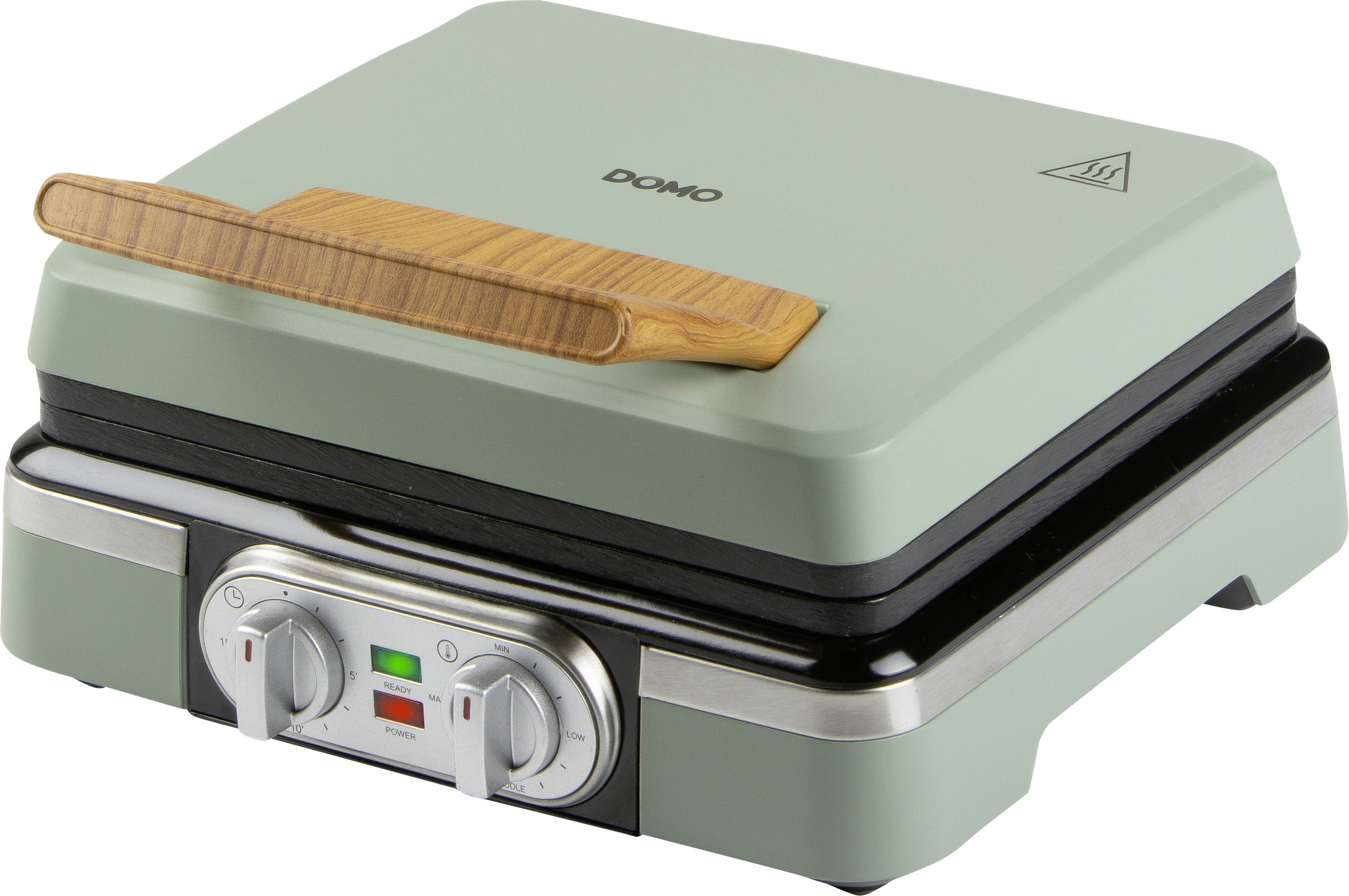 Eine grüne Sandwichpresse mit einem Holzgriff, ausgestattet mit Einstellrädern und Kontrollleuchten an der Vorderseite zur Temperatur- und Leistungssteuerung.