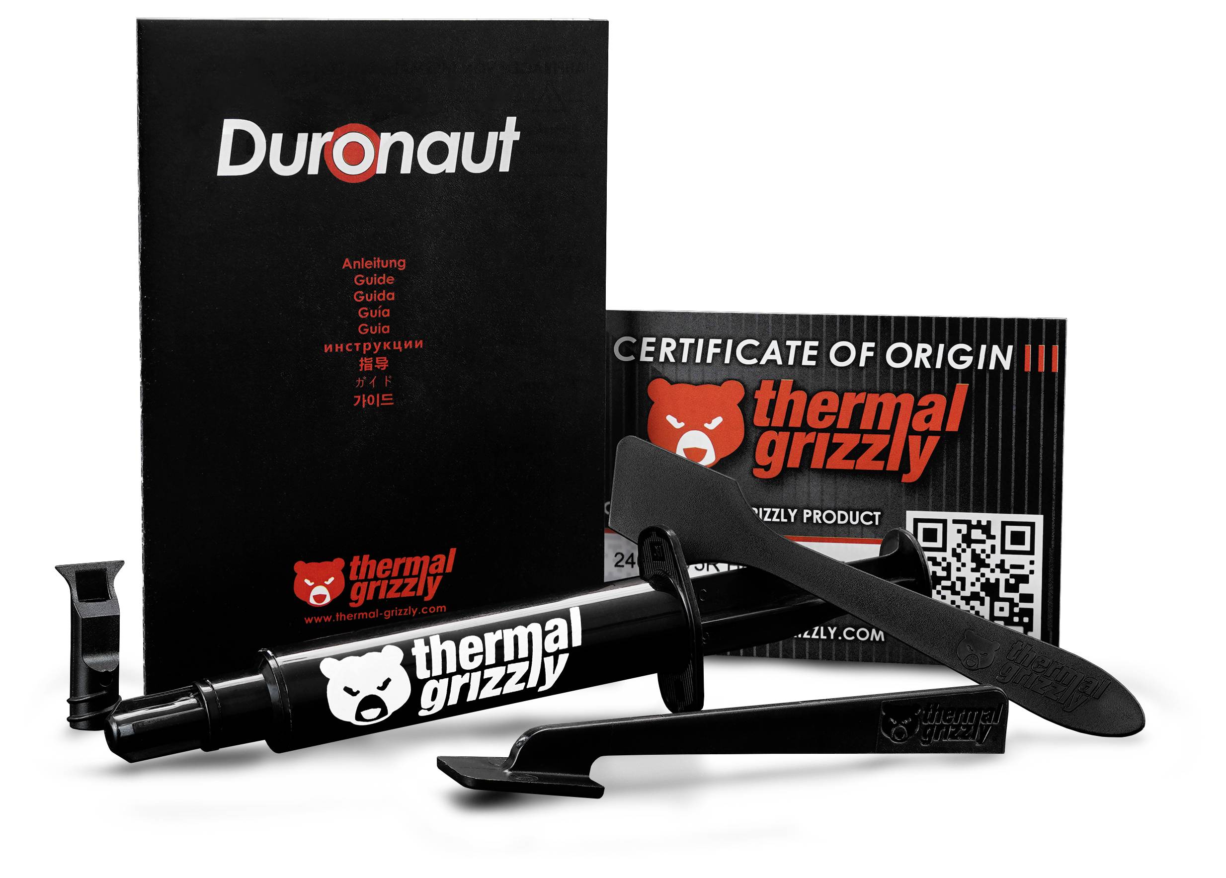 Spritze mit Thermal Grizzly Wärmeleitpaste mit Applikator und 'Duronaut' Schachtel, neben einer 'Ursprungszertifikat'-Karte.