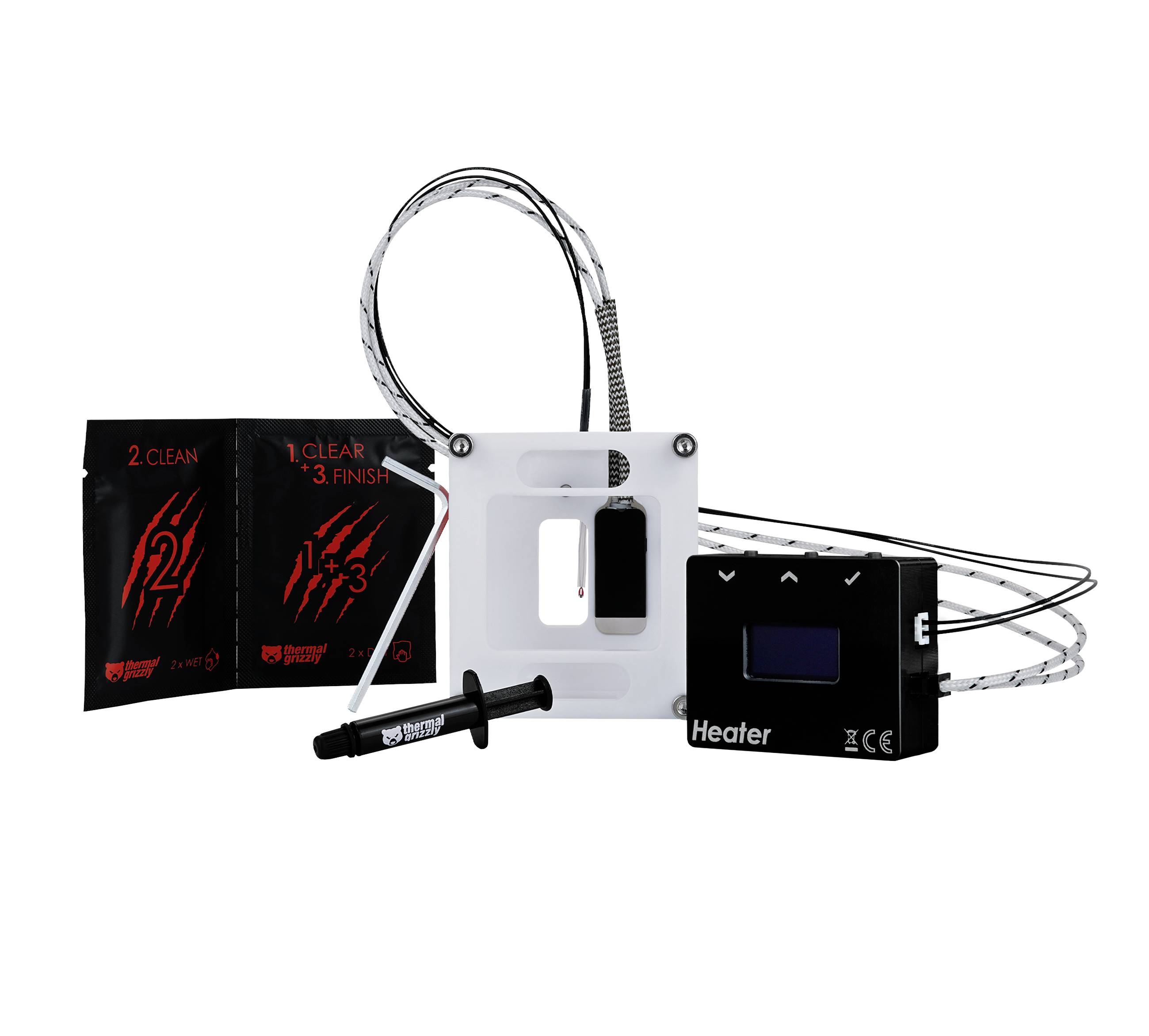 'Rebel 3 in 1' Heizgerät-Set: schwarzer Heizstrahler, weißer Montagerahmen, Spritze, zwei schwarze/rote Klebepakete und Kabelung.