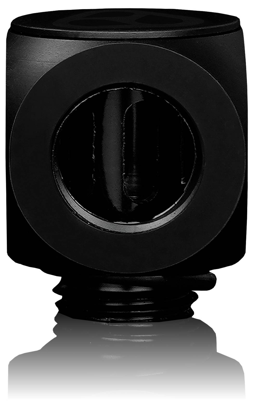 Ein schwarzes, zylindrisches Objekt mit einer sichtbaren kreisrunden Öffnung in der Mitte, auf einer reflektierenden Oberfläche platziert.