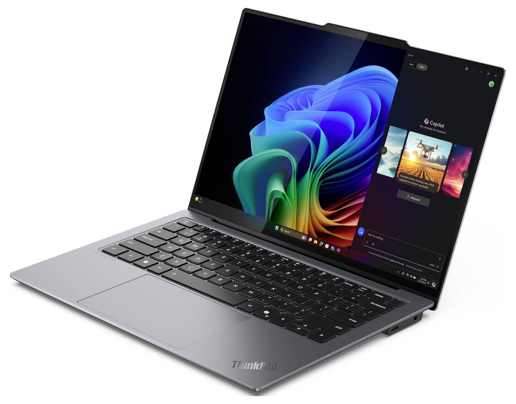 Ein silberner Laptop mit einem farbenfrohen Bildschirmanzeige, der eine Windows-Benutzeroberfläche zeigt und eine geöffnete 'Spotify'-App auf der rechten Seite.