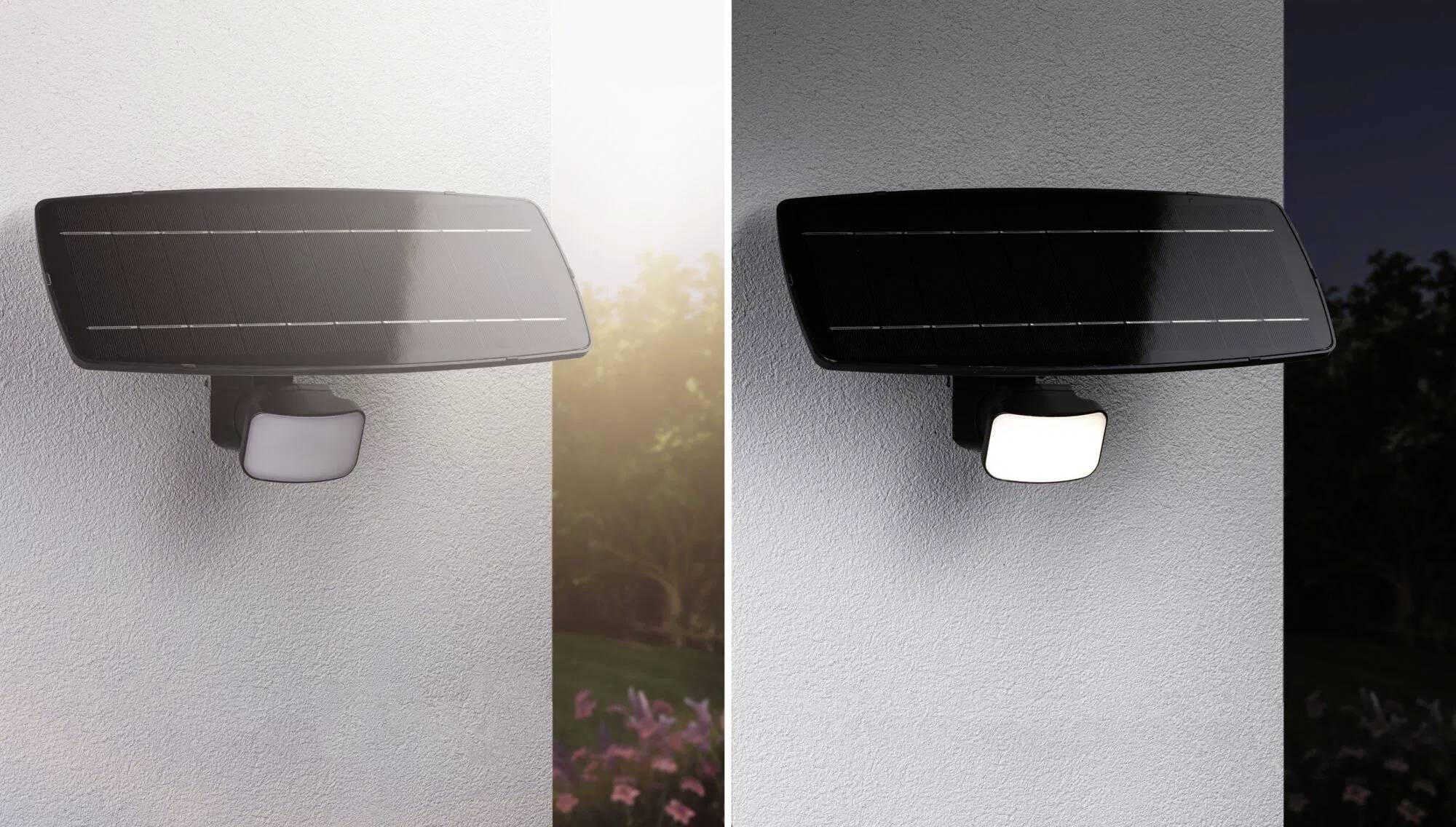 Eine Sicherheitsleuchte mit einem Solarpanel an einer Wand, die bei Tag gezeigt und bei Nacht beleuchtet wird, mit Gartenlandschaft im Hintergrund.