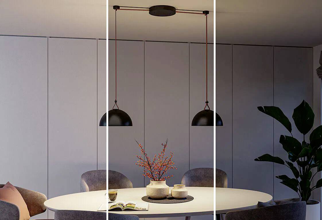 Ein Essbereich mit einem runden Tisch, Stühlen, einer Pflanze und Pendelleuchten darüber. Ein Mittelstück mit Beeren und einem aufgeschlagenen Buch auf dem Tisch.