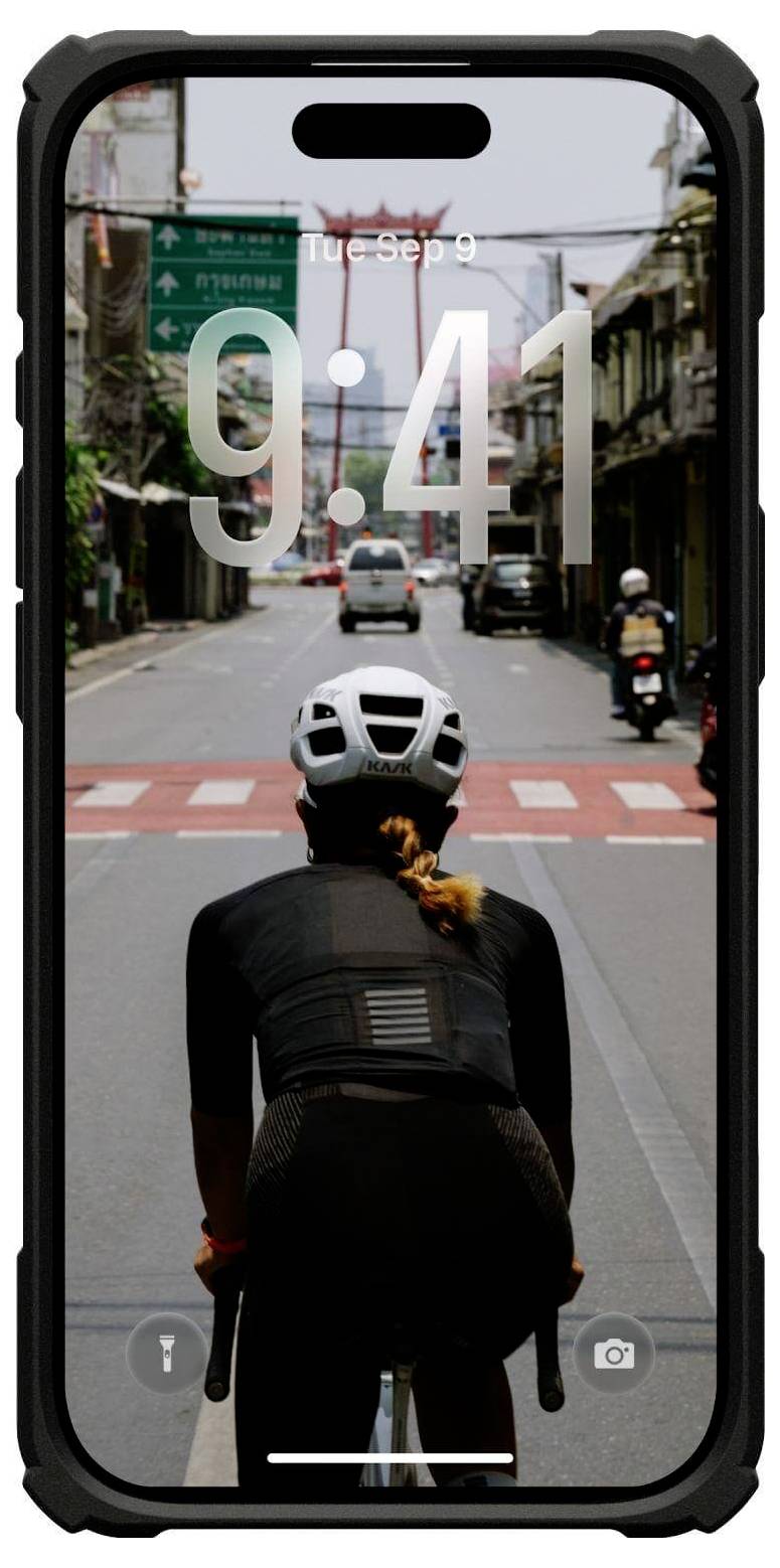 Ein Radfahrer in schwarzer Kleidung fährt auf einer Stadtstraße auf einen Fußgängerüberweg zu, gesehen durch den Bildschirm eines Smartphones, auf dem 9:41 Uhr und 'Die, 9. Sep' angezeigt werden.