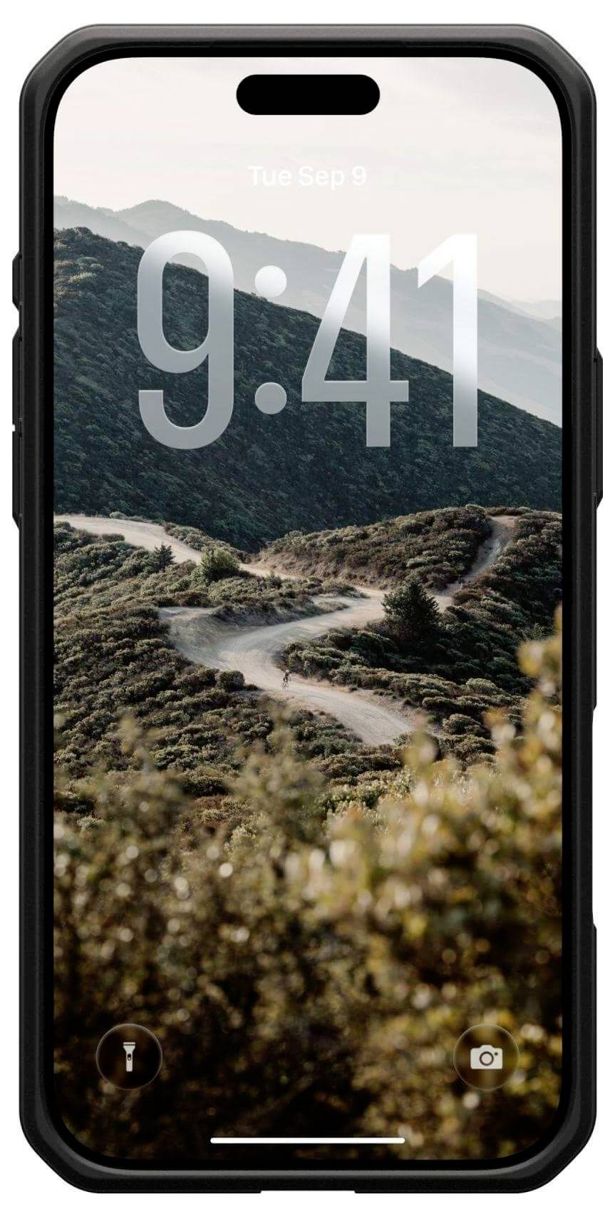 Ein Smartphone zeigt einen Sperrbildschirm mit einer Uhrzeit von 9:41 über einer malerischen Bergstraßenansicht, umgeben von Grün und einem klaren Himmel.
