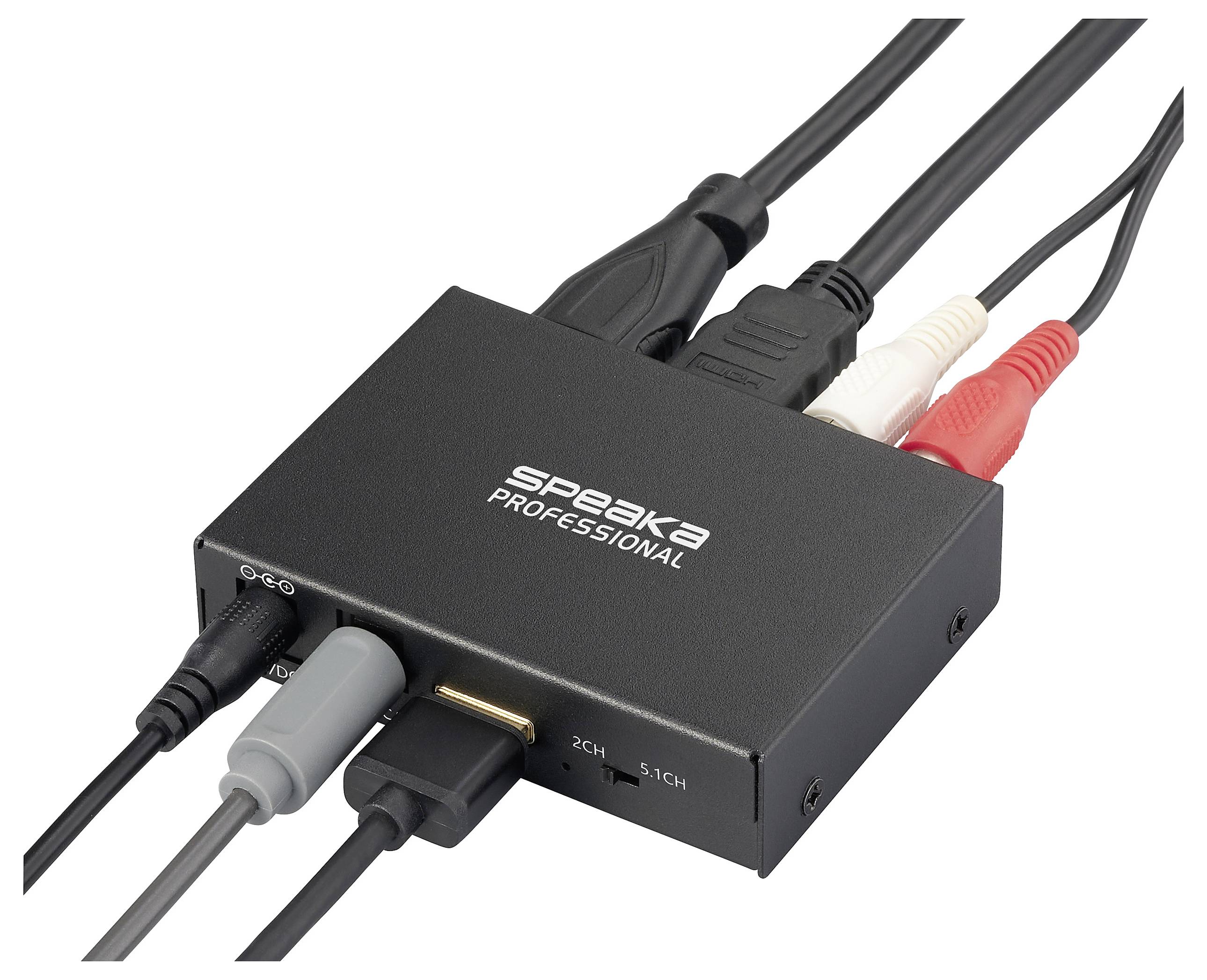 Ein schwarzer Audiokonverter mit mehreren angeschlossenen Kabeln, beschriftet mit 'Speaka Professional', zum Konvertieren zwischen 2-Kanal- und 5.1-Kanal-Audio.