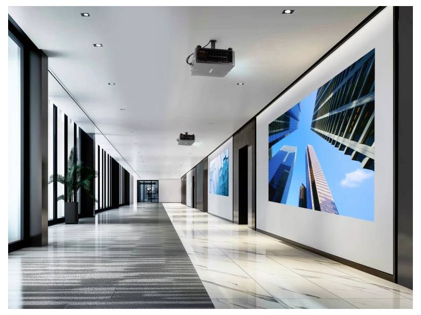 Ein geräumiger Flur mit moderner Einrichtung und großen Bildschirmen, die abstrakte Bilder von hohen Gebäuden zeigen, mit elegantem Licht und hellen Fliesen.