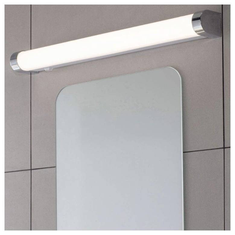 Ein rechteckiger, an der Wand montierter Spiegel mit einer horizontalen zylindrischen Leuchte darüber, vor einem gefliesten Wandhintergrund.