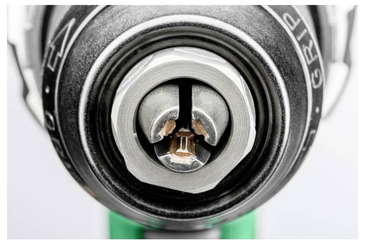 Nahaufnahme eines Schraubendreherkopfes, der mit einer Schraube in Kontakt ist und eine präzise Ausrichtung zeigt. Die Details des Werkzeugs sind messerscharf fokussiert.