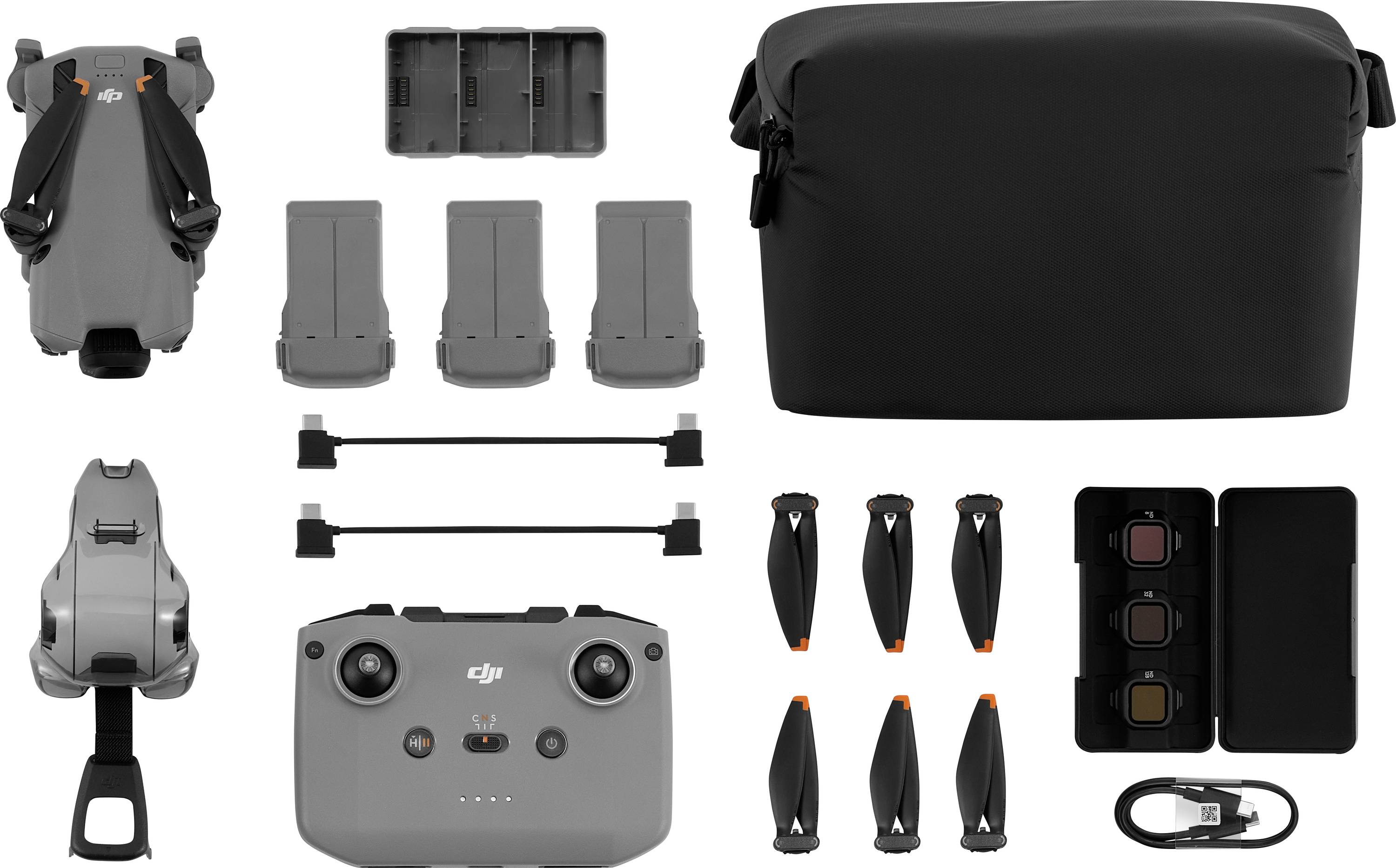 Drohne und Zubehör: Drohnengehäuse, Fernbedienung, drei Batterien, Ladehub, Tragetasche, Propellerblätter und Filter.