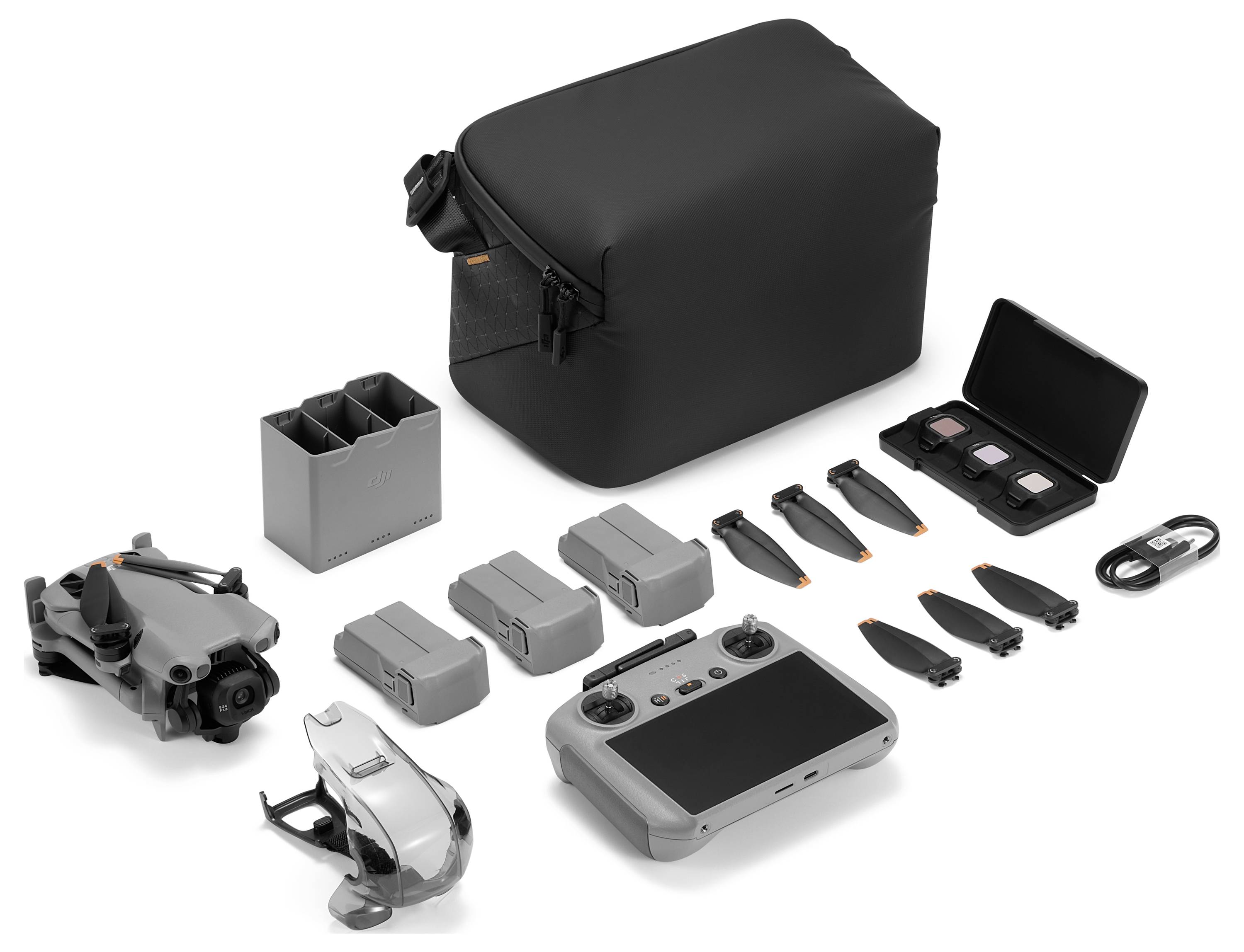 Ein Drohnen-Set enthält eine Drohne, eine Fernbedienung, drei Akkus, Propeller, eine Ladestation, einen Propellerhalter, Filter, einen Adapter und eine Tragetasche.