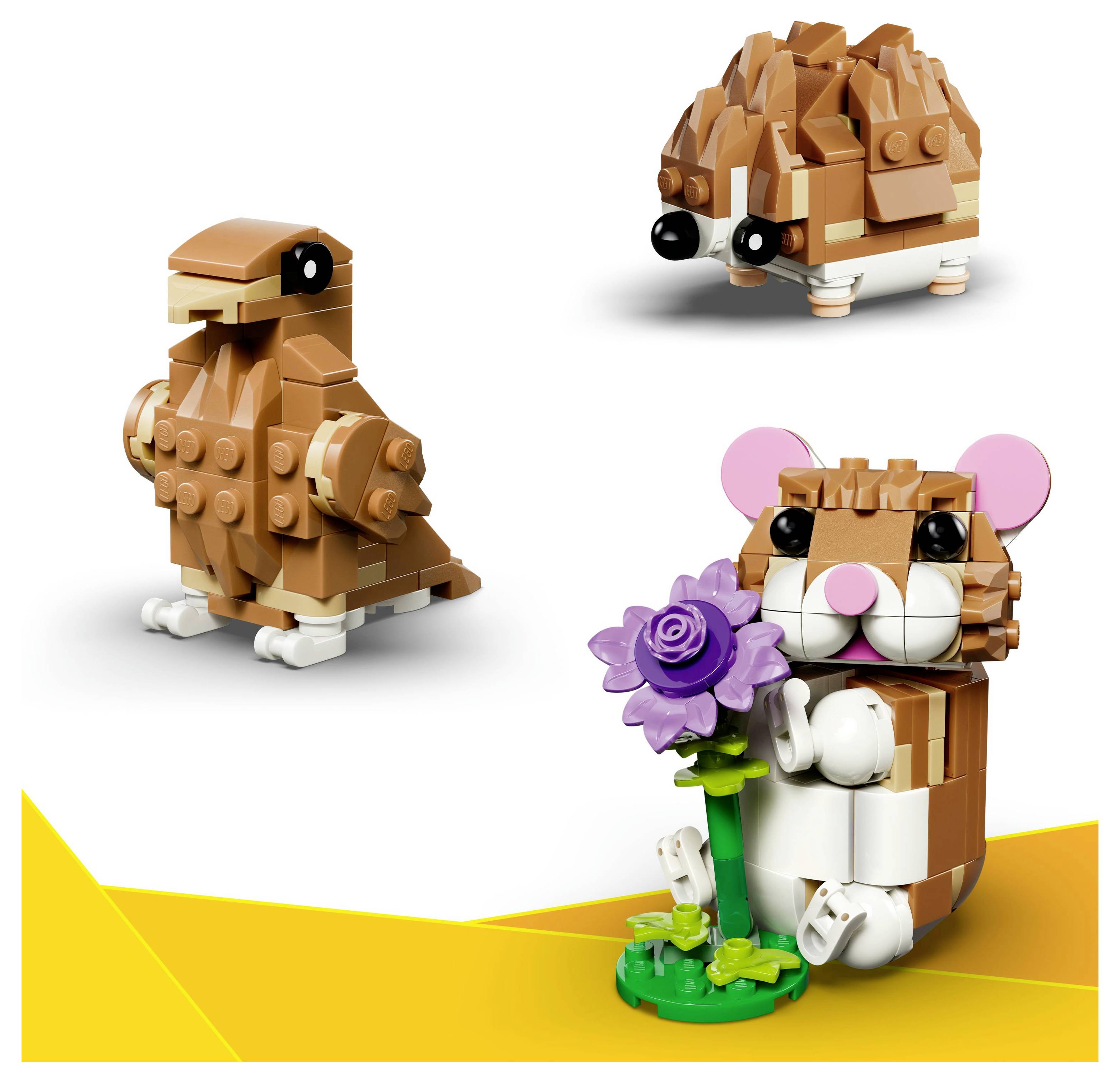 Lego-Modelle einer Taube, eines Igels und eines Hamsters, der eine lila Blume hält. Jedes Tier ist mit braunen und beigen Steinen gebaut.