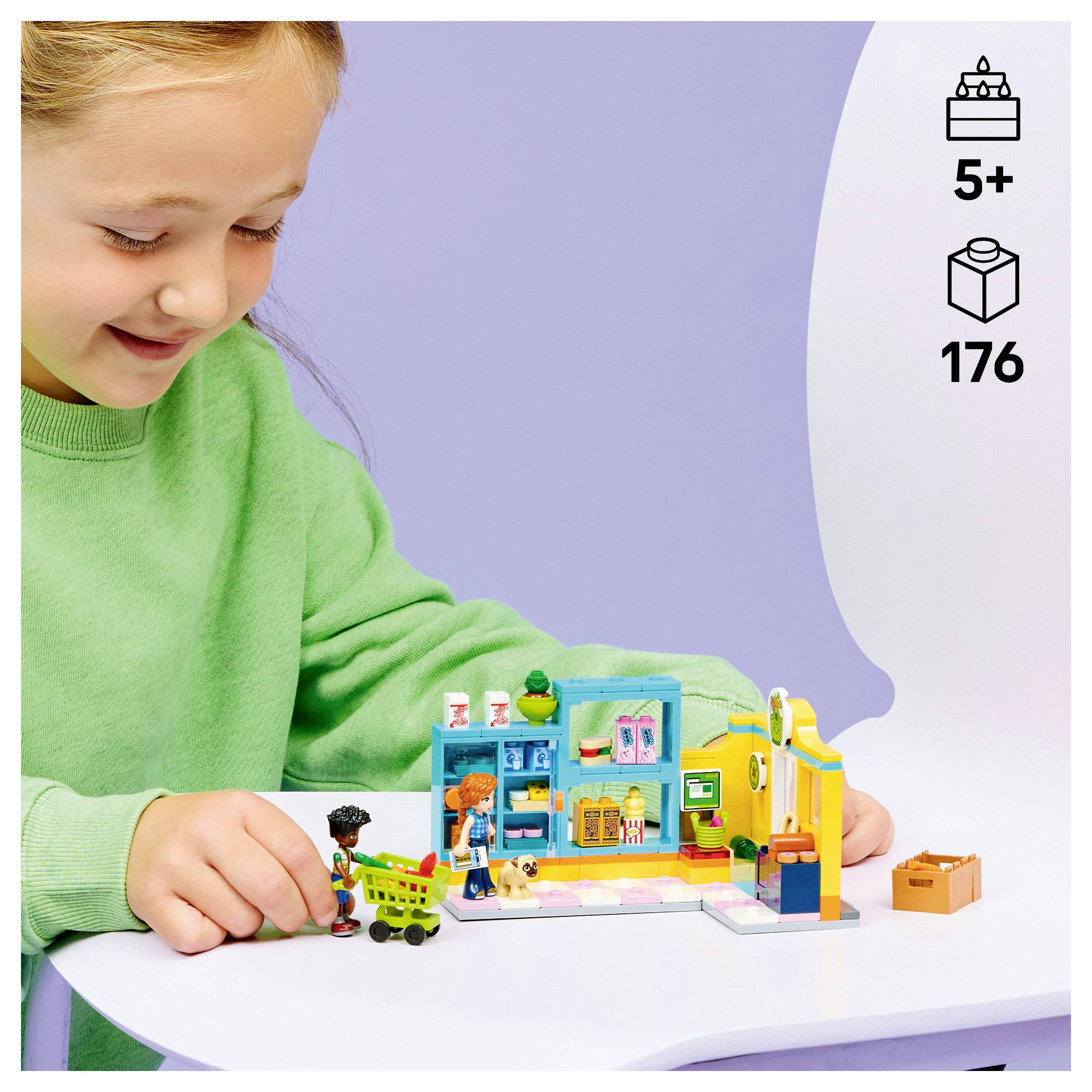 Ein Kind in einem grünen T-Shirt spielt mit einem bunten Baukasten. Die Verpackung zeigt, dass er für Kinder ab 5 Jahren geeignet ist und 176 Teile enthält.
